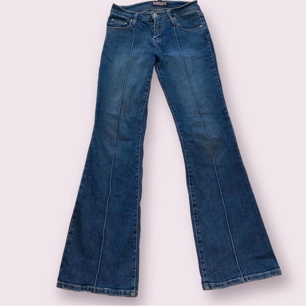 Low-rise bubblegum flare jeans! Unique stitching down front and star buttons
